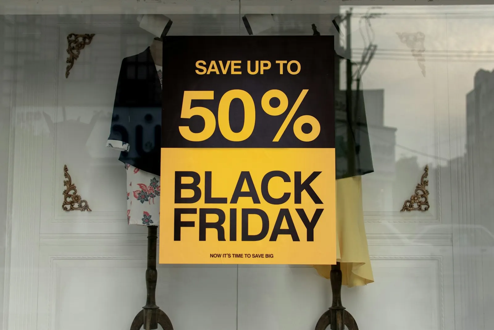 Shop window sign reading Save up to 50% Black Friday